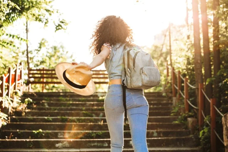 Photo from back of teenage woman 18-20 wearing summer clothes an