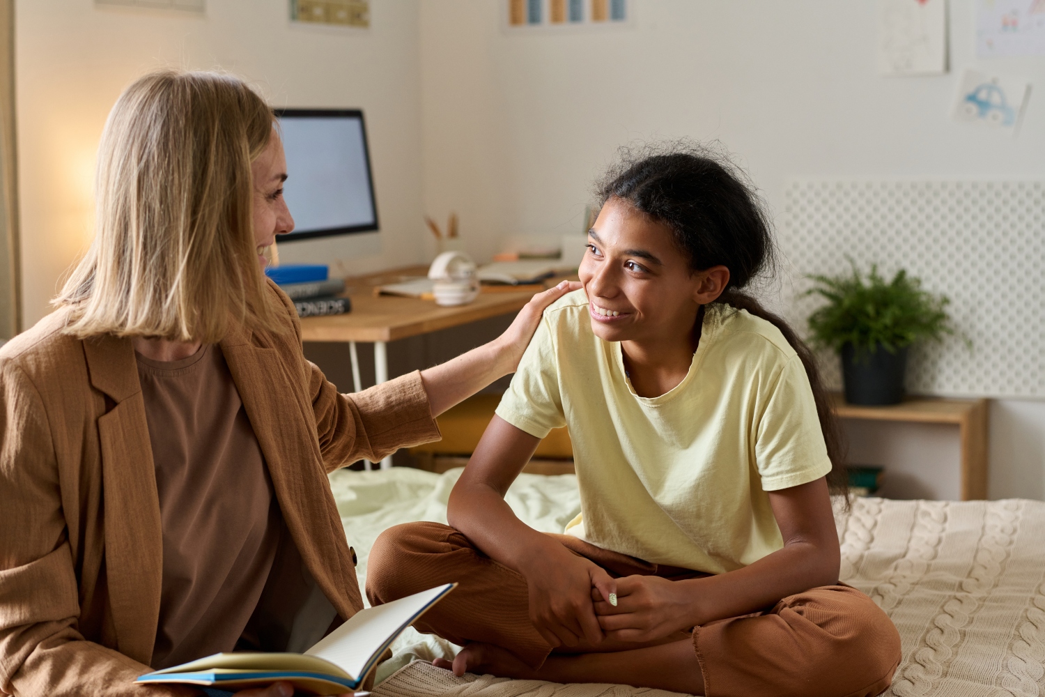 Teenage girl talking to psychologist at home