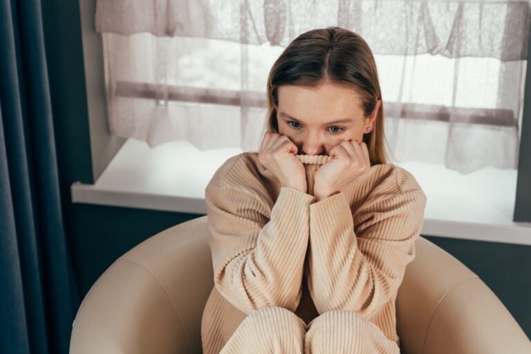girl sits on chair feels depressed, offended or lonely
