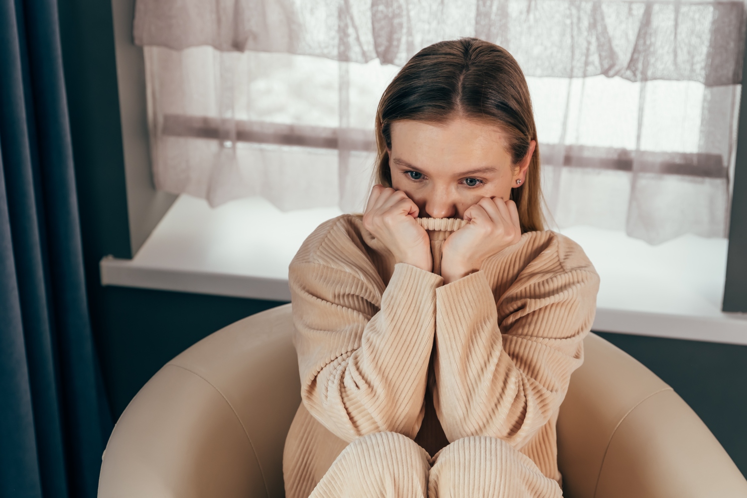 girl sits on chair feels depressed, offended or lonely