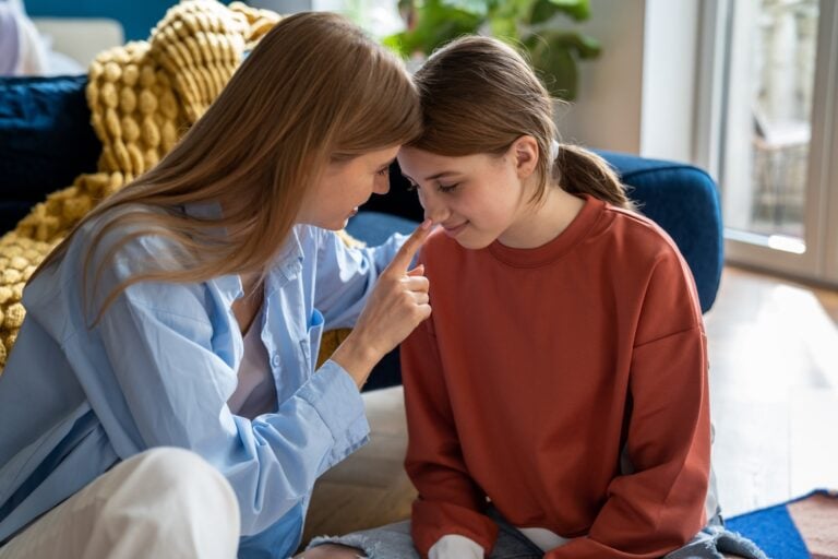mother connects with teenage daughter, concept of support and wellness