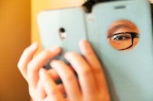 Closeup portrait of teen kid using mobile device