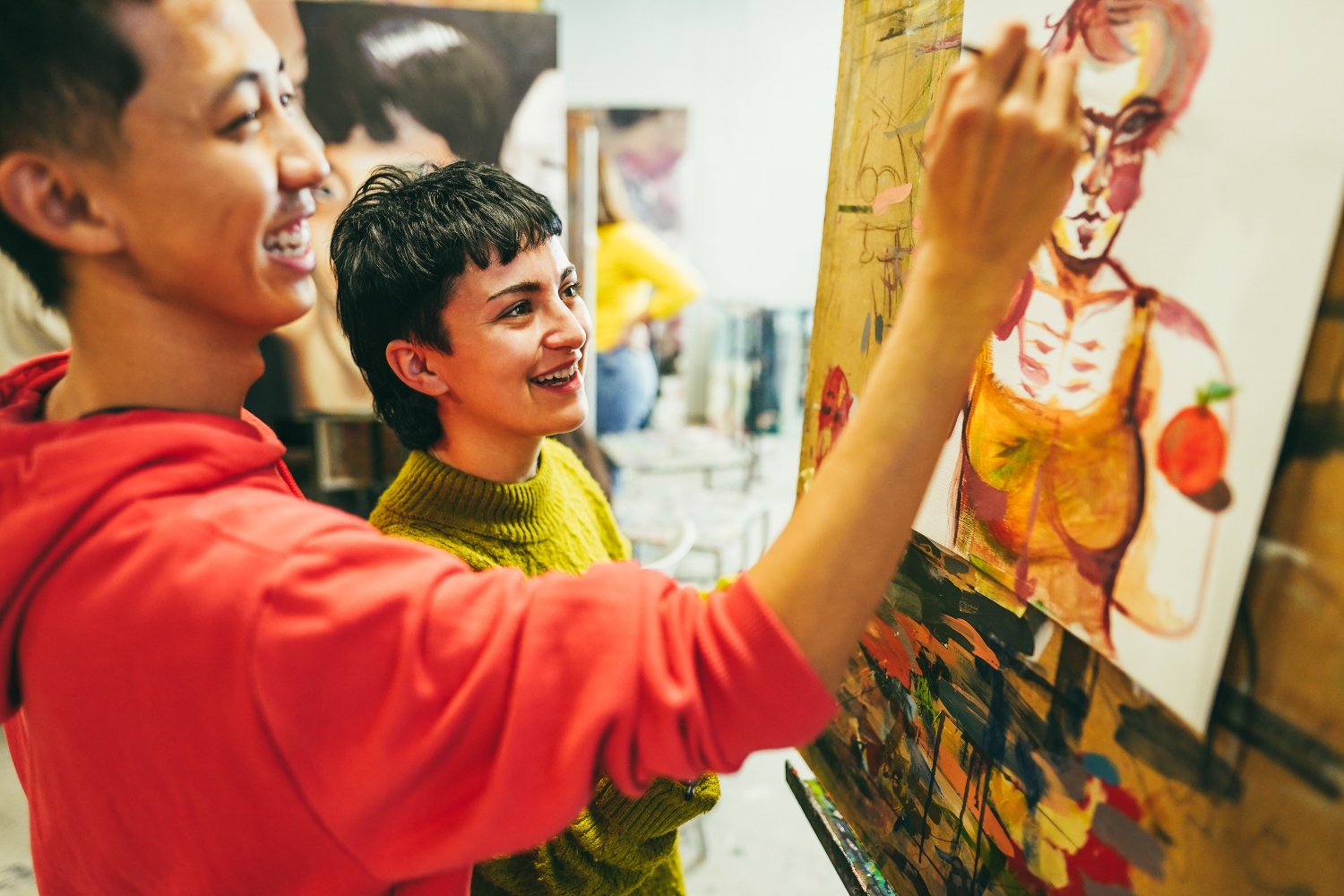 Multiracial students painting during art therapy session