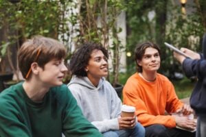 group of young teenagers listening in a group discussion