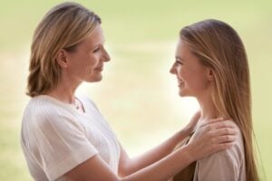 A loving mother being affectionate towards her daughter