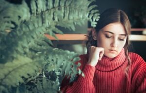 shot of a young teenage girl sitting alone in a care, concept of mental health