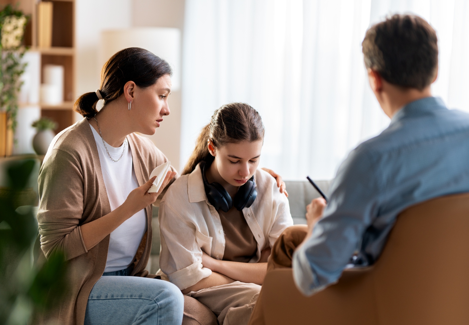 mother and teenage daughter during a counseling session, concept of family therapy