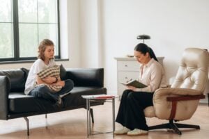 teenage girl sitting on a couch during a counseling or therapy session