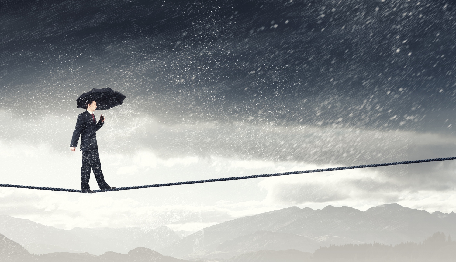 image of a businessman standing and crossing a tight rope, concept of mental health and business