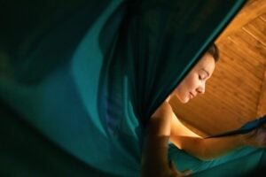 image of a young girl with her eyes closed, accented with green cloth