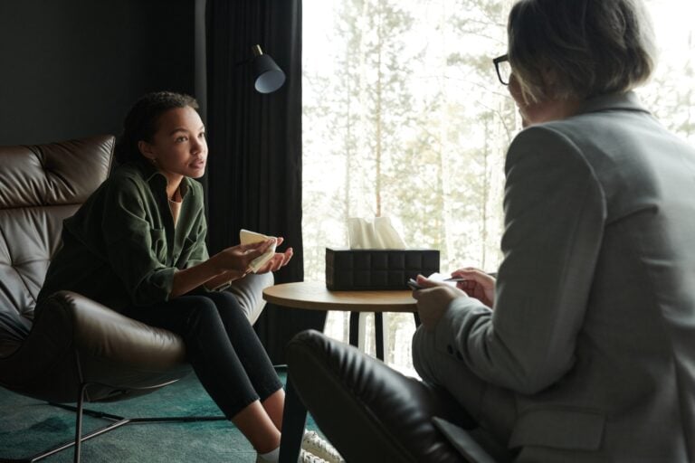 teenage girl explaining her problem to counselor during a mental health therapy session