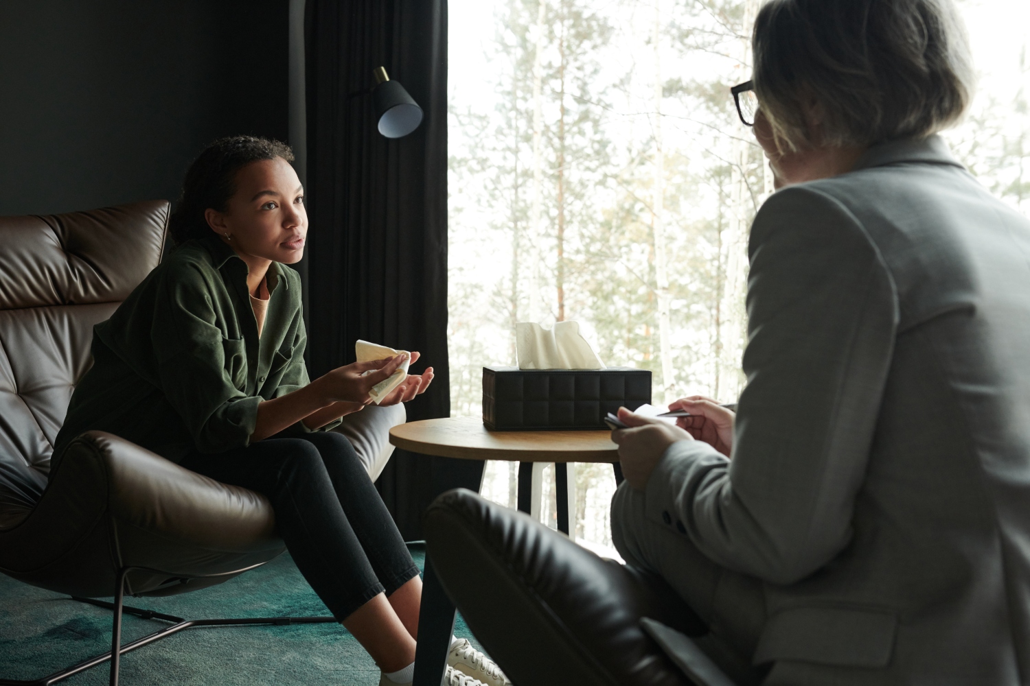 teenage girl explaining her problem to counselor during a mental health therapy session