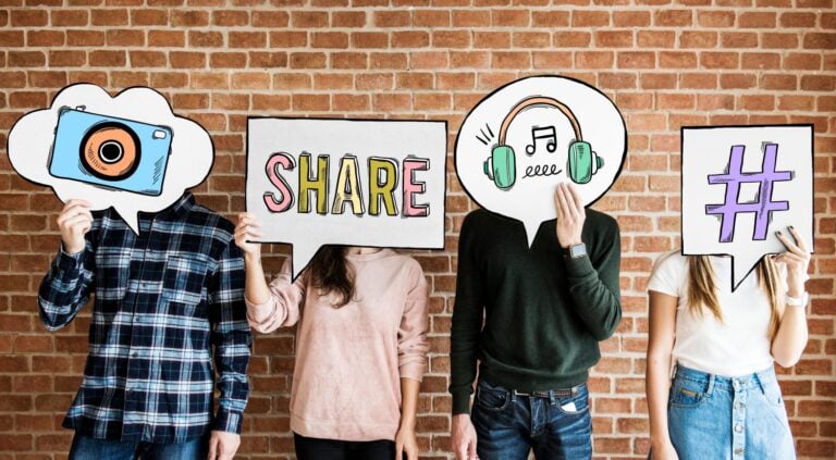 Friends holding up thought bubbles with social media concept icons