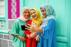 Arabian Friends Using Smartphone For Making Selfie Story On Social Network App