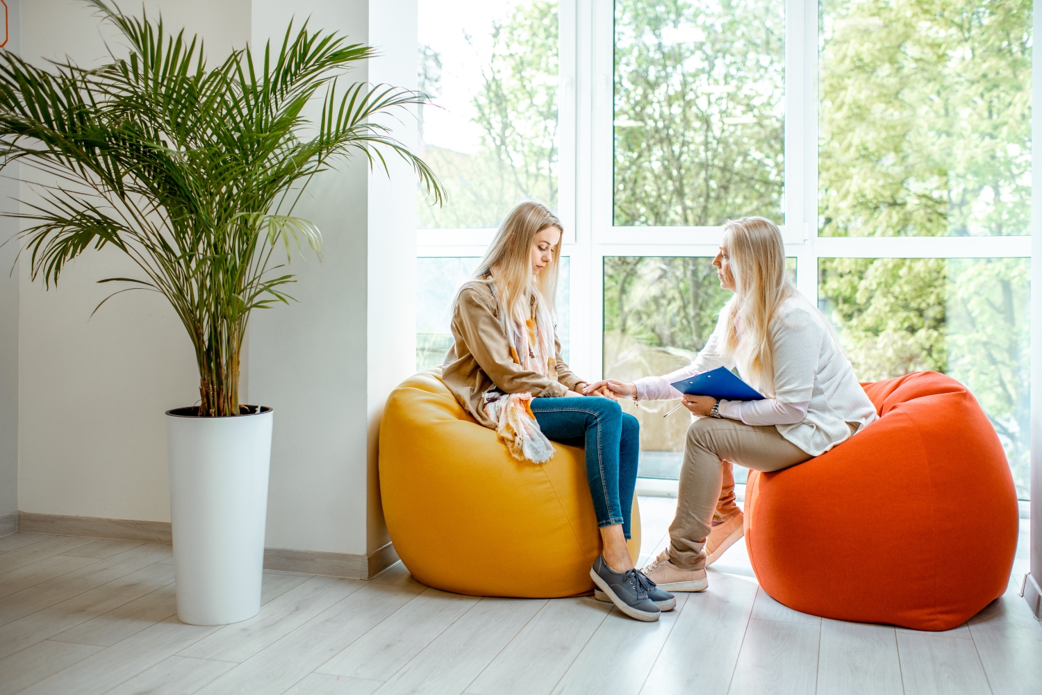 Teenage girl speaking with psychologist in the office