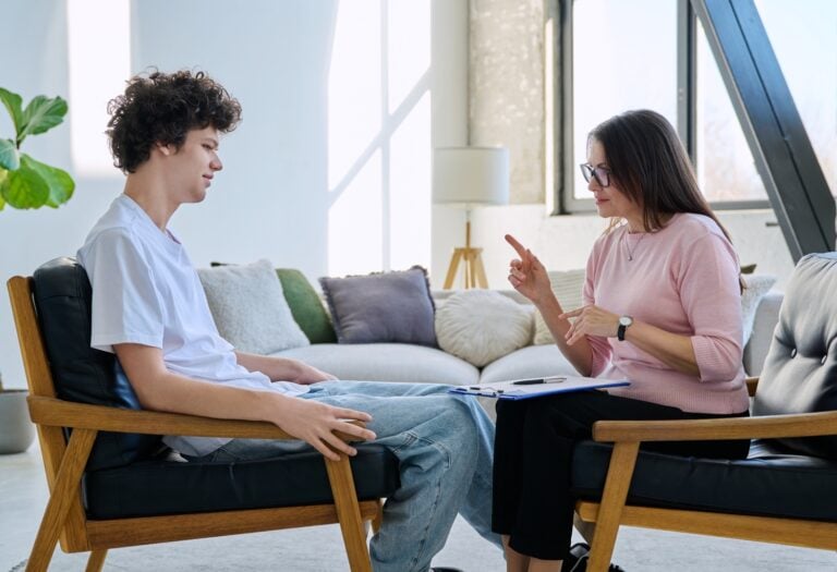 teenager talking to a counselor or therapist, concept of mental health treatment