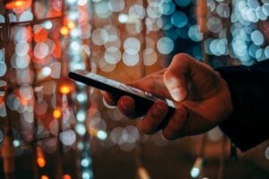 Hand Holding and Using a Phone at Night