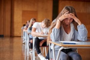 focused shot on a teenage girl while taking an exam at school